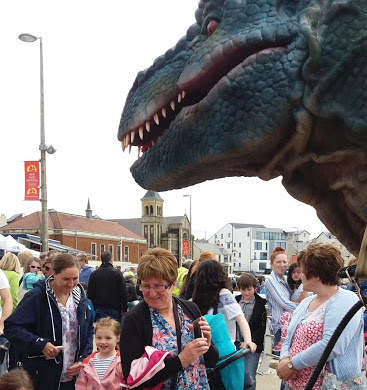dinosaur entertaining crowds